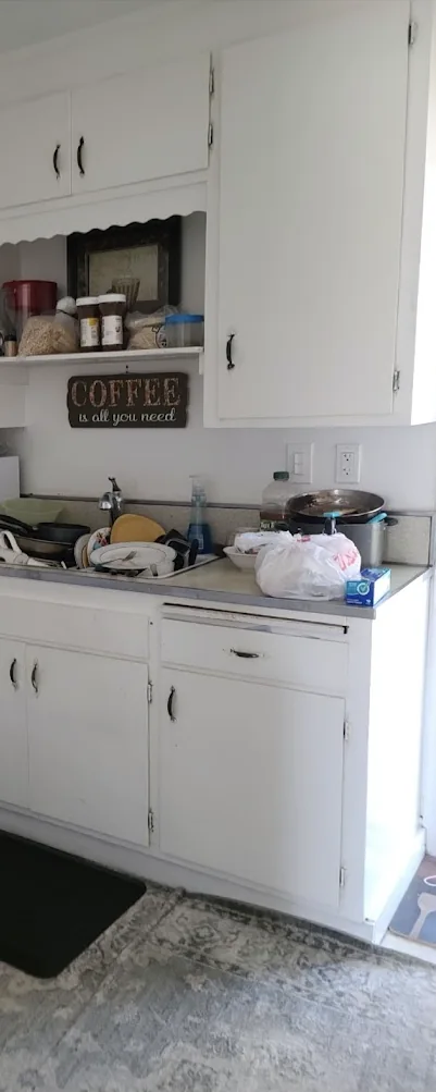 Before cleaning: kitchen counter with dishes and objects